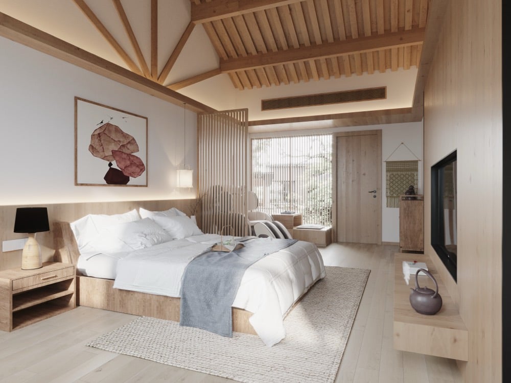 A resort bedroom with a made-up king bed beneath a vaulted timber ceiling.