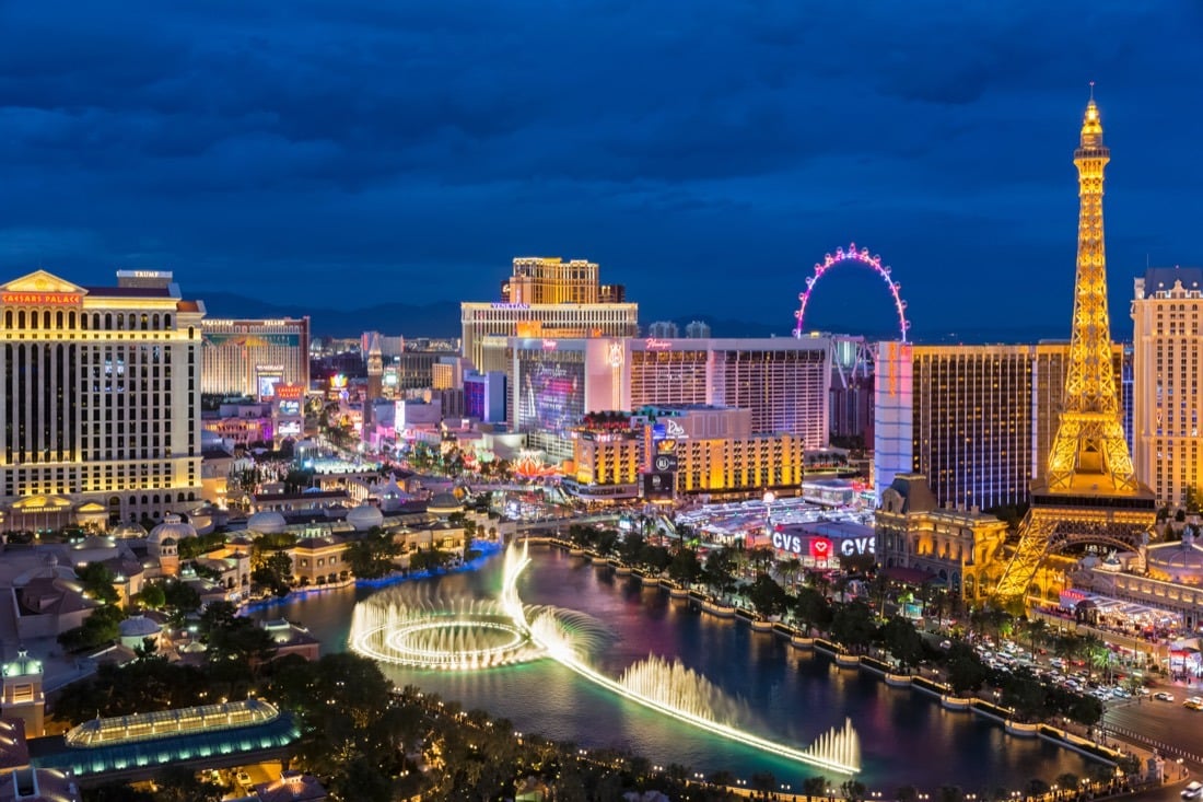 The Las Vegas Strip lit up at night, with fountains in the foreground.