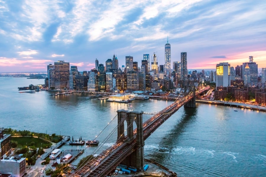 The Brooklyn Bridge and the Manhattan skyline at dusk.