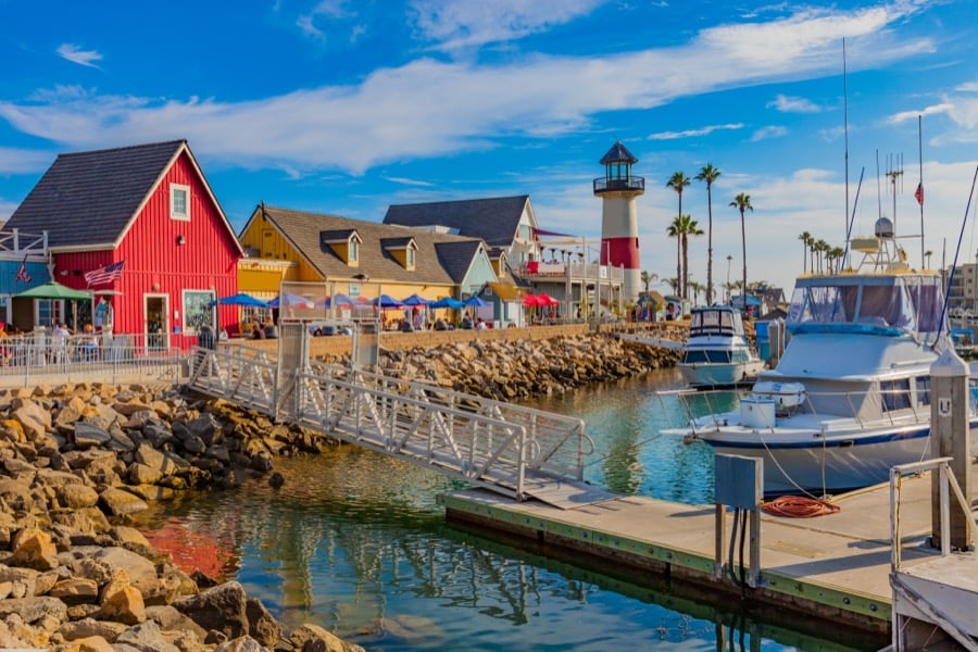 Fishing boats moored beside the red harbour buildings at Oceanside.