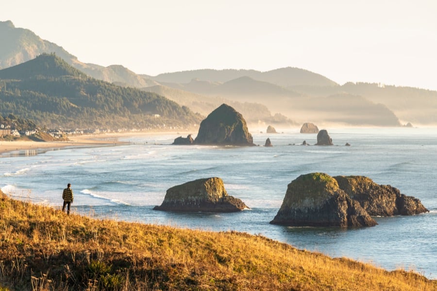 Haystack Rock and sea stacks off the Seaside, Oregon shore at sunset.