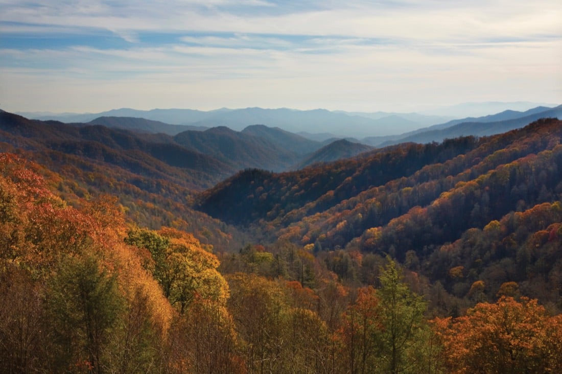 Layered ridgelines receding into haze above autumn forest in the Smoky Mountains.