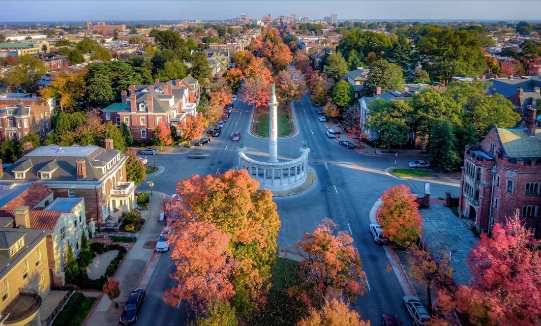 A colonial-era street in Williamsburg lined with autumn trees.